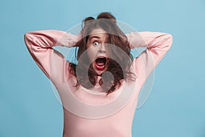 The squint eyed woman with weird expression isolated on blue