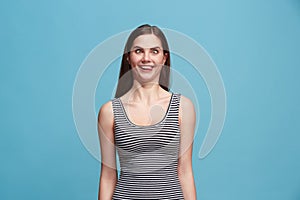 The squint eyed woman with weird expression isolated on blue