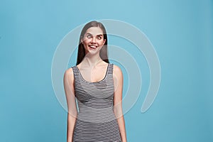 The squint eyed woman with weird expression isolated on blue