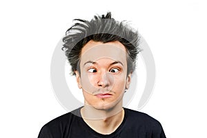 Squint young guy with long hair at an appointment with an ophthalmologist on white isolated background