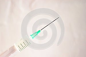 Squirting syringe needle with medicine for medical intramuscular injection on white background