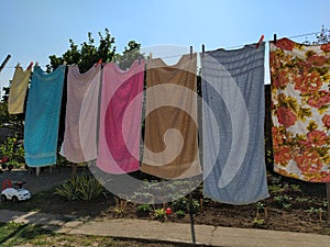 Sremska Mitrovica, Serbia July 10, 2020, towels and clothes dry on a rope. Housewife worries. The wet cloth is hung on clothespins