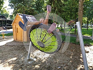 Sremska Mitrovica, Serbia, 13 September 2020. Children swing on a spider-web swing. Boy and girl, brother and sister in the summer