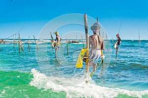 In Sri Lanka, a local fisherman is fishing in unique style in the evening