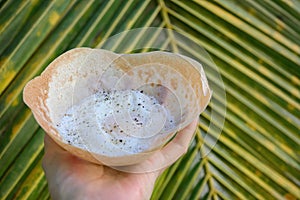 Sri lankan street food egg hopper in hand. Outdoors.