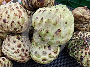 Srikaya fruit or annona squamosa at local market central java, indonesia photo