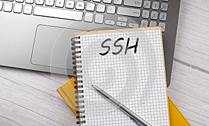 SSH text written on a notebook on the laptop