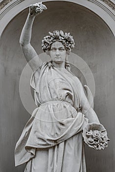 Statue of sensual busty and puffy renaissance era woman in circlet of flowers, Potsdam, Germany, details, closeup