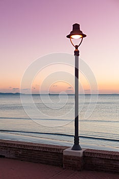 Sstreetlamp and sea at dusk