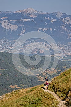 Couple of hikers walk on slopes of Belledonne mountain range near Refuge Jean Collet