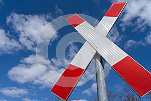 St. Andrew cross railway sign in the blue sky