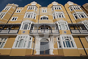 St Aubyns Mansions on Kings Esplanade. Restored mustard coloured block of flats overlooking the sea in Hove, East Sussex UK.