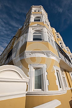 St Aubyns Mansions on Kings Esplanade. Restored mustard coloured block of flats overlooking the sea in Hove, East Sussex UK.