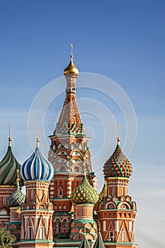 St. Basil`s Cathedral on Red Square in Moscow against the background of a bright blue sky on a sunny day. Vertical