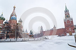 St Basil Temple and Spasskaya Tower of Kremlin during snowstorm
