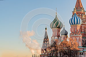 St Basils cathedral on Red Square in Moscow and smoking pipes of power plant on sunset