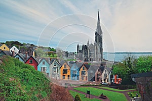 St. Colman`s Cathedral And Colored Houses In Cobh, Ireland