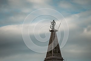 St. Euphemia bell tower with saint statue on the top, rising high above the town of Rovinj, Croatia