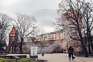 St. Florian\'s Gate  Brama Florianska with towers and tourists walking. Famous places of interest and ancient landmarks photo