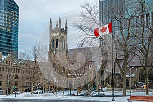 St. George`s Anglican Church at Canada Square with flag - Montreal, Quebec, Canada