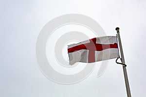 St George`s cross flag  against a pure white sky photo