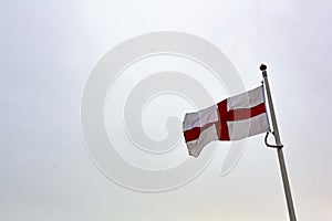 St George`s cross flag isolated against a pure white sky photo