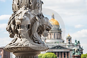 St. Isaac& x27;s Cathedral out of focus, in the foreground the sculpture of lions on a pole, Saint-Petersburg, Russia.