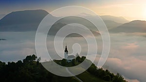 St.Ivan, Slovenia - 4K arial footage about drone flying around Sveti Ivan Church on a sunny foggy sunrise with Slovenian Alps