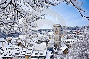 The St. Johan church tower over the old town roofs after a winter snow fall