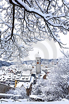 The St. Johan church tower over the old town snow roofs