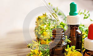 St. John`s wort flower oil in glass bottle. selective focus