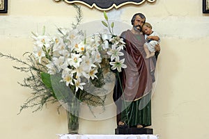 St Joseph holding child Jesus, statue in the Parish church of St. Catherine of Alexandria in Komarevo, Croatia