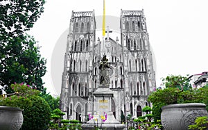 St. Joseph`s Cathedral and Regina Pacis Queen of Peace Statue in front, Hanoi, Vietnam. St. Joseph`s Cathedral is a Neogothic photo