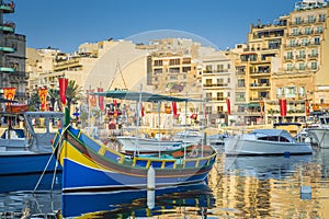 St.Julian`s, Malta - Colorful Luzzu fishing boats at Spinola bay photo
