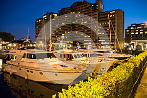 St Katharine dock in London at night, UK. Modern yacht and boat pier