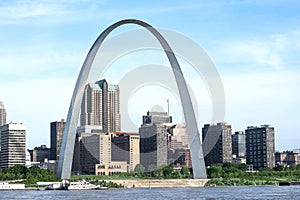 St louis gateway arch on mississippi river at daytime river barge in foreground