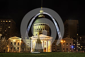 St Louis, Missouri, Dec 2019 - St Louis Gateway Arch and Old Courthouse at night with Christmas tree in front