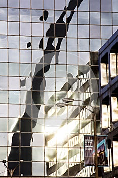 Gateway Arch reflected in glass high-rise office building downtown