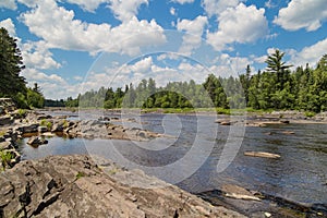 St. Louis River runs through a rocky streambed through a pine wo