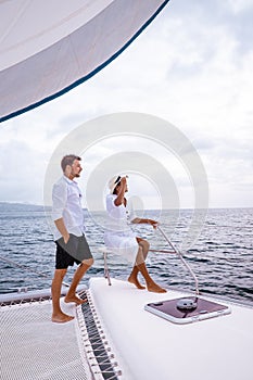 St Lucia, couple men and woman watching sunset from sailing boat in the Caribbean sea near Saint Lucia or St Lucia