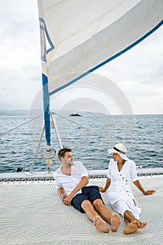 St Lucia, couple men and woman watching sunset from sailing boat in the Caribbean sea near Saint Lucia or St Lucia