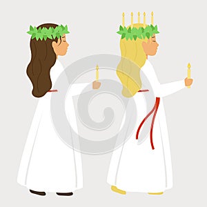 St. Lucia day. A girl in a white dress and a wreath of candles holding a candle. photo