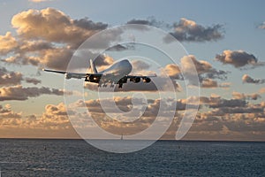 St Maarten, Caribbean, Maho Bay airport Boeing 747 KLM arriving out of the sunset from over the ocean