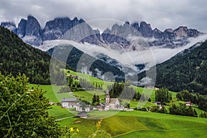 St Magdalena church in Val di Funes valley, Dolomites, Italy. Furchetta and Sass Rigais mountain peaks in background