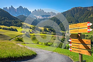 St. Magdalena village road sign with church in Val di Funes, Dolomites , Italy