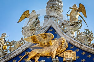 St Mark Basilica facade detail, with lion and angels, Venice, Italy