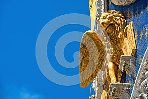 St Mark`s basilica or San Marco closeup, beautiful rooftop on blue sky background, Venice, Italy. Detail of ornate exterior