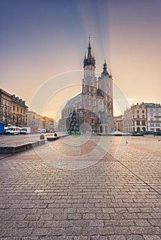 Krakow old town, Market square with St. Mary`s church at sunrise, historical center cityscape, Poland, Europe