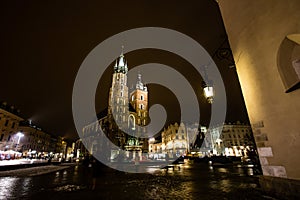 St. Marys Basilica at night, with night lamp visible and dramatic lights, Krakow, Poland