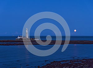 St Marys Island and lighthouse with moon and copy sace